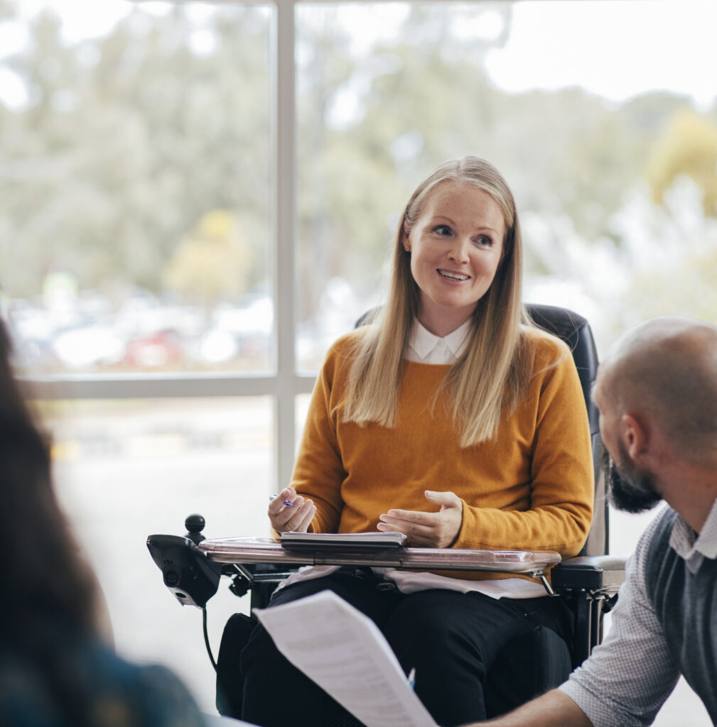 Woman using a wheelchair leading a meeting.