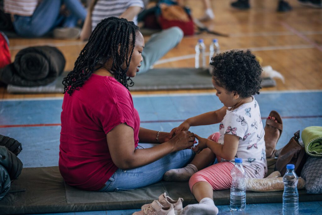Mother And Child In Shelter After Natural Disaster