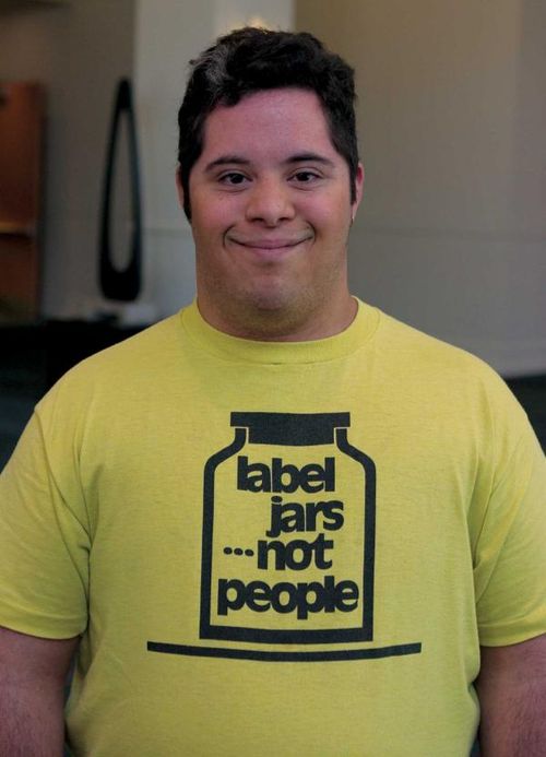 Young man with Down's Syndrome wearing t-shirt that reads "label jars...not people".