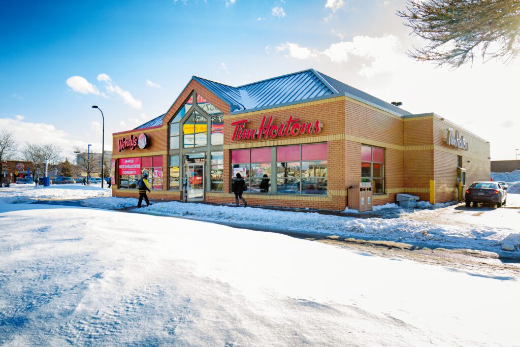 Retail stores with snow cleared accessible sidewalk leading to the doorway and around the building.